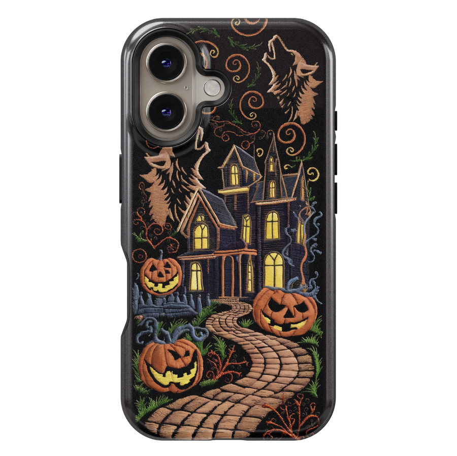 Embroidered haunted house iPhone case with glowing jack-o'-lanterns, spooky trees, howling wolves, and a winding path on a black background. Halloween-ready.
