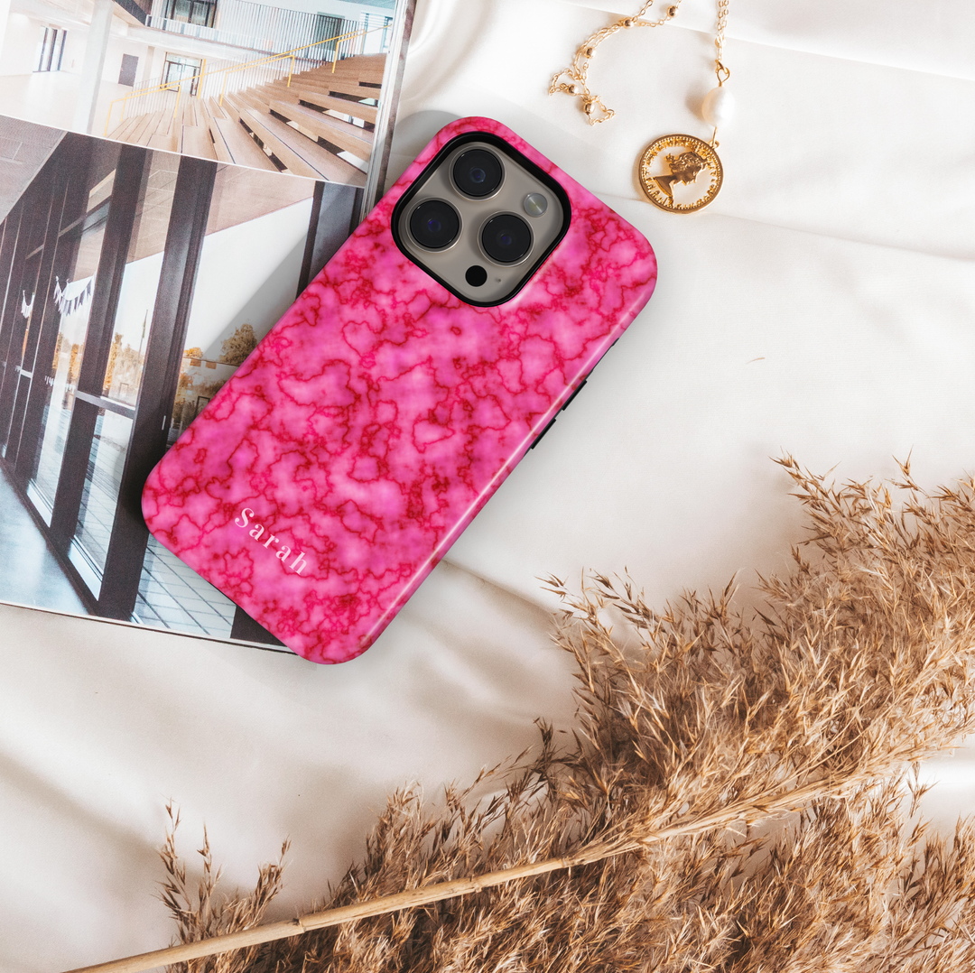 Personalized pink marble iPhone case with custom name detail. Girly glossy finish, stylish protection, and a soft blush aesthetic. Compatible with multiple iPhone models.