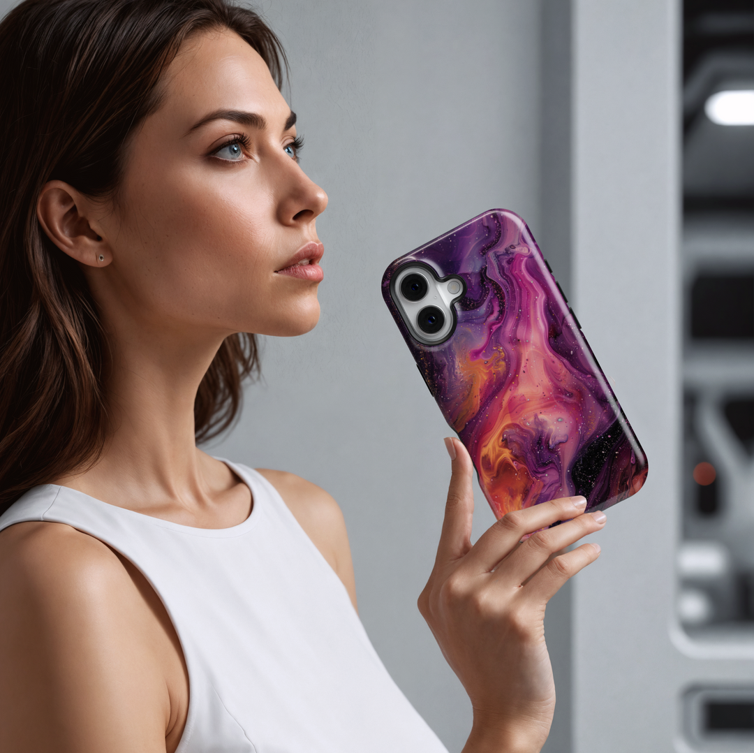 Vibrant iPhone case with a swirling abstract galaxy design in purples, oranges, and black; bold MagSafe-compatible tough case for iPhone 16.

