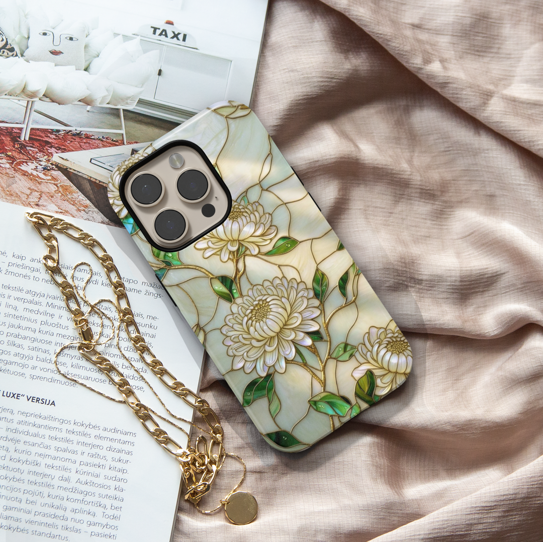 Ivory floral iPhone 17 Pro Max case with white chrysanthemum flowers and gold detailing, pearl aesthetic MagSafe tough case.