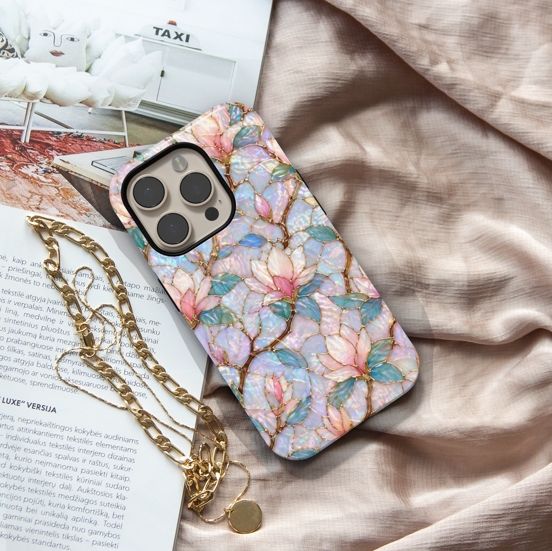 Magnolia floral iPhone 17 Pro Max case with iridescent opal background and gold detailing, aesthetic MagSafe tough case.