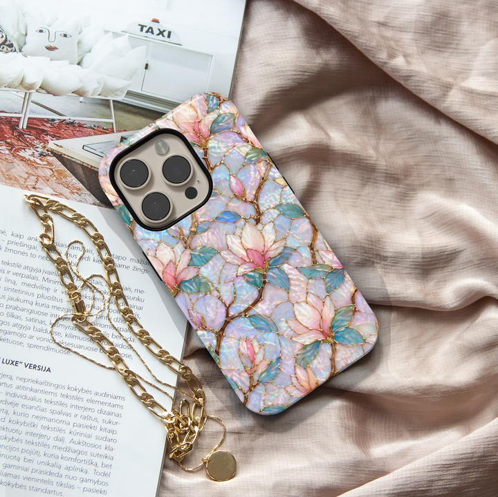 Magnolia floral iPhone 17 Pro Max case with iridescent opal background and gold detailing, aesthetic MagSafe tough case.