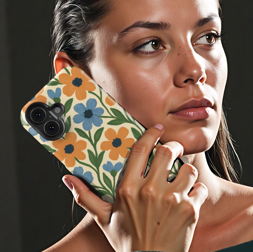 Vintage floral iPhone case featuring blue and orange hand-painted flowers with green leaves on a cream background.