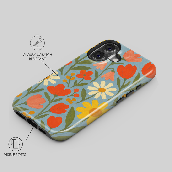 Retro floral iPhone case featuring colorful daisies, tulips, and wildflowers on a soft blue background with vintage folk art styling.