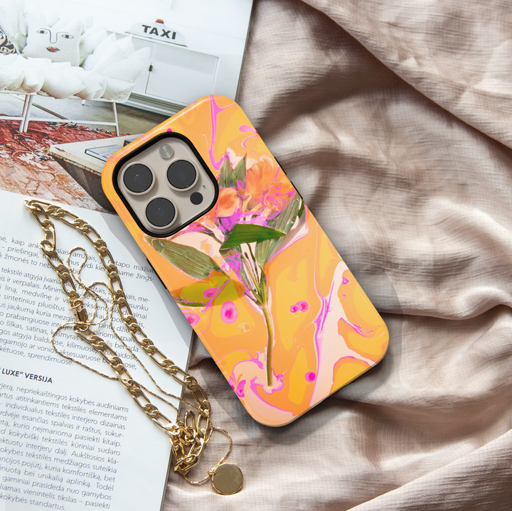 Abstract floral iPhone case featuring vibrant orange flowers with yellow and pink marbled artwork in a modern botanical design.