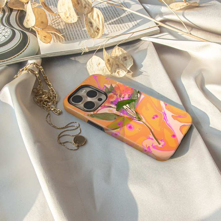 Abstract floral iPhone case featuring vibrant orange flowers with yellow and pink marbled artwork in a modern botanical design.