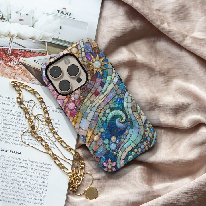 Blue ocean wave iPhone case featuring stained glass mosaic artwork with shimmering pearls, pastel skies, and coastal-inspired abstract design.