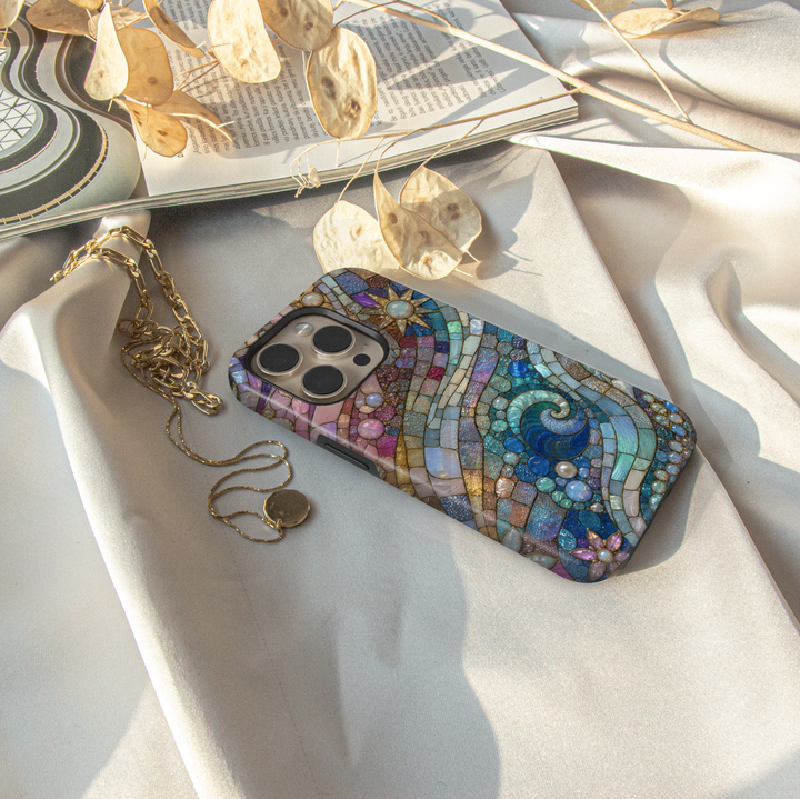 Blue ocean wave iPhone case featuring stained glass mosaic artwork with shimmering pearls, pastel skies, and coastal-inspired abstract design.