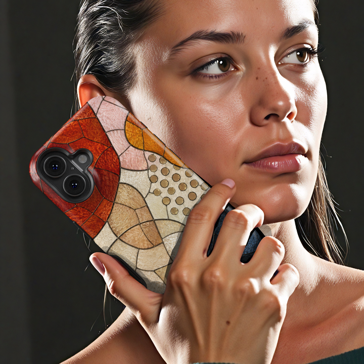 Modern abstract iPhone case featuring neutral geometric mosaic shapes in terracotta, cream, caramel, and navy tones.