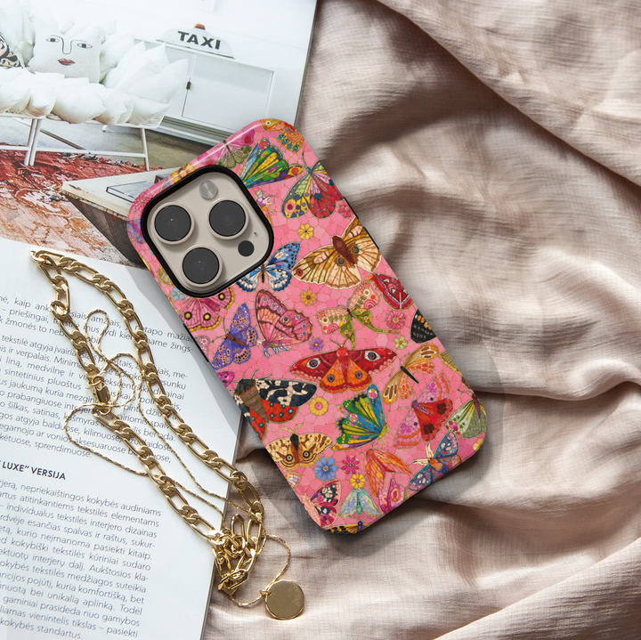 Pink butterfly iPhone case featuring colorful butterflies, moths, flowers, and whimsical nature-inspired artwork.