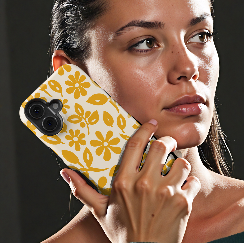 Minimalist yellow floral iPhone case featuring retro daisy flowers and botanical leaves on a soft ivory background.
