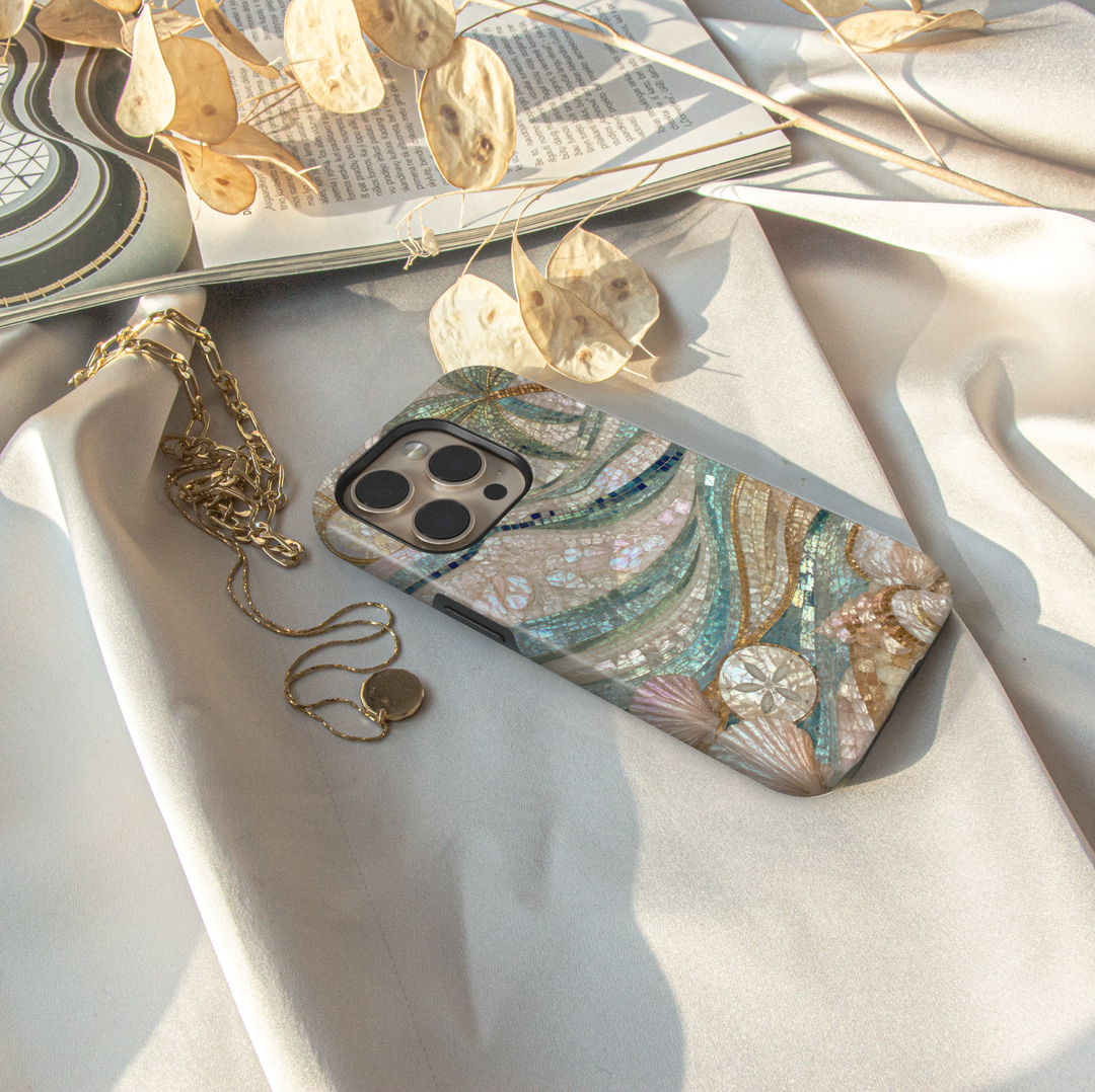 Elegant iPhone case featuring mosaic ocean waves, seashells, sand dollars, pearl details, and luxurious coastal artwork.