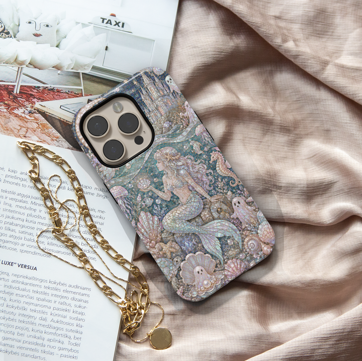 Elegant iPhone case featuring a pearlescent mermaid with cute ghosts, seashells, jellyfish, seahorses, and luxurious underwater ocean artwork.