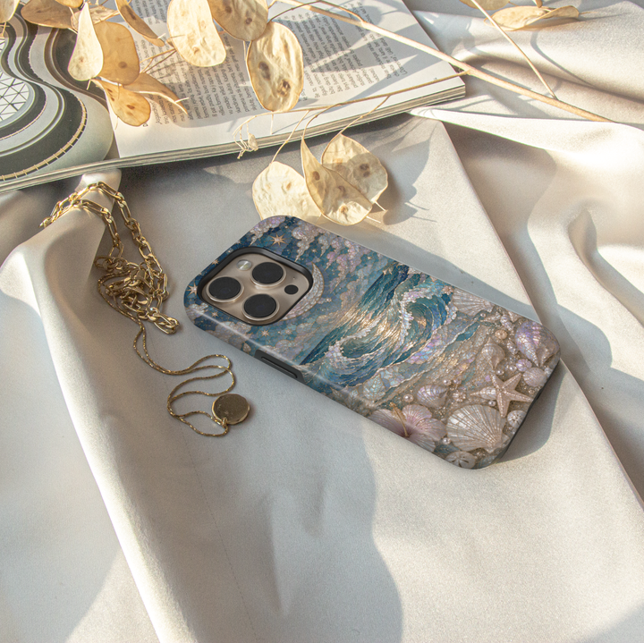 Elegant ocean wave iPhone case featuring moonlit sea, pearlescent seashells, starfish, and luxurious coastal artwork.