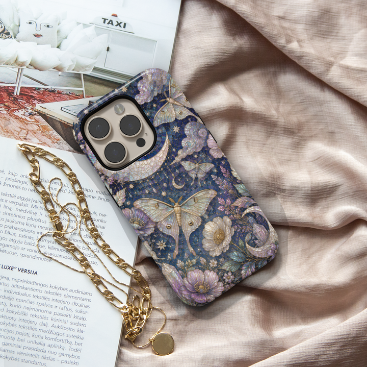 Celestial iPhone case featuring luna moths, crescent moon, stars, lavender flowers, clouds, and elegant midnight floral artwork.