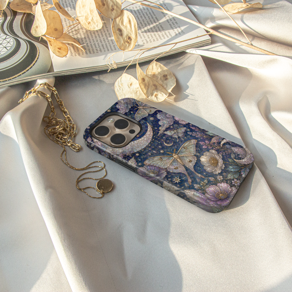 Celestial iPhone case featuring luna moths, crescent moon, stars, lavender flowers, clouds, and elegant midnight floral artwork.
