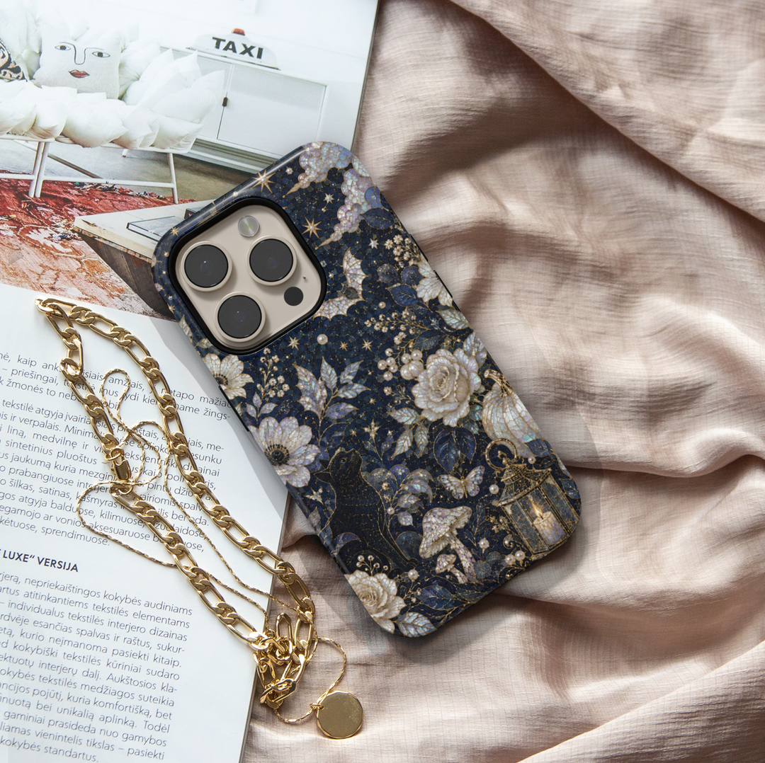 Midnight Halloween iPhone case featuring black cat, full moon, pearl roses, lantern, mushrooms, pumpkins, butterflies, and elegant gothic botanical artwork.