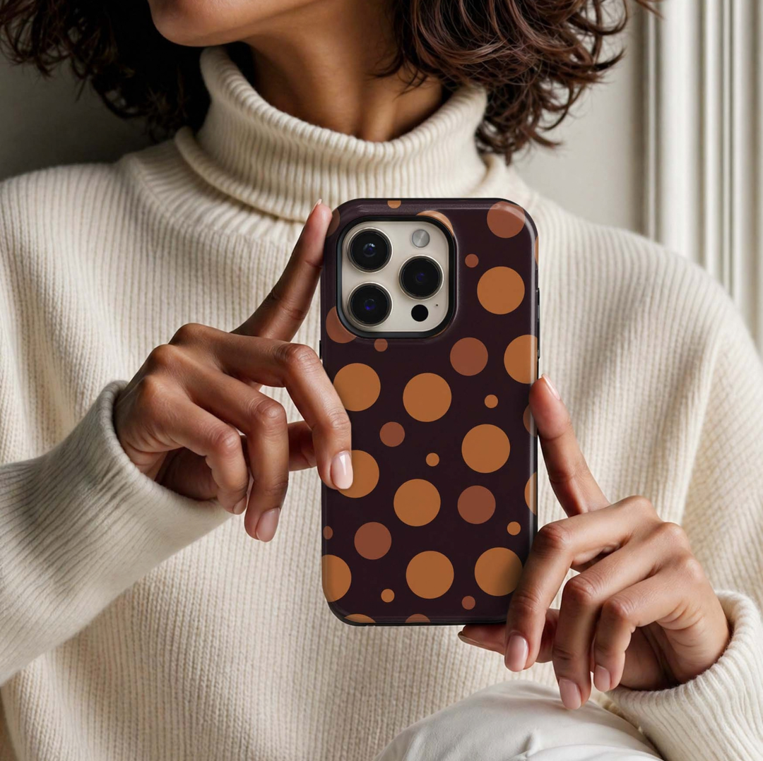 Pumpkin Pop Tough iPhone Case featuring large and small pumpkin orange, caramel and terracotta polka dots on a deep espresso brown background.