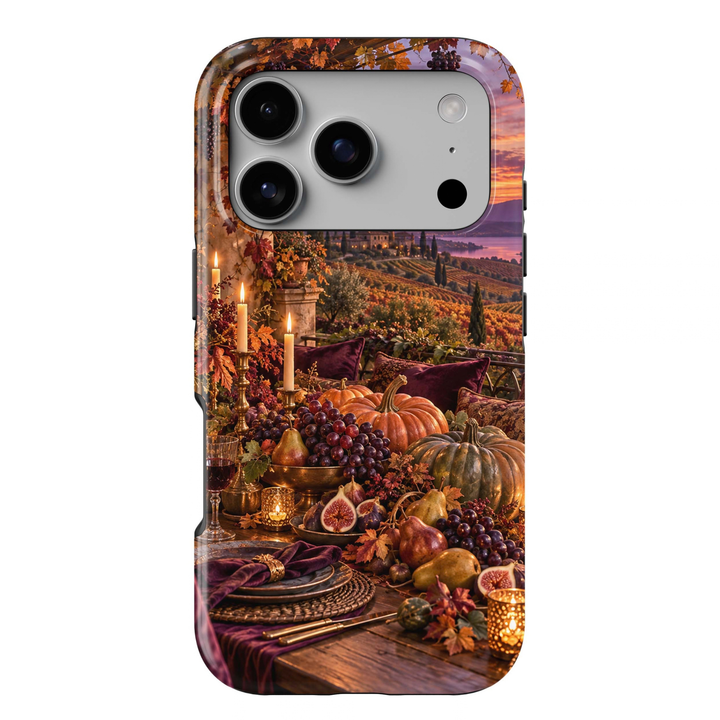 Harvest Table Tough iPhone Case featuring an elegant autumn tablescape with pumpkins, grapes, figs, pears, glowing candles and burgundy accents overlooking a vineyard at sunset.