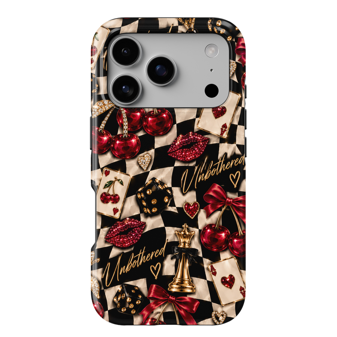CASELIX Cherry Checkmate iPhone 18 Pro Max tough phone case featuring a black and cream checkerboard pattern with glossy red cherries, jeweled lips, gold chess pieces, playing cards, dice, red satin bows, and gold Unbothered lettering. Trendy preppy checkerboard phone case for women with a bold, glamorous, girls&
