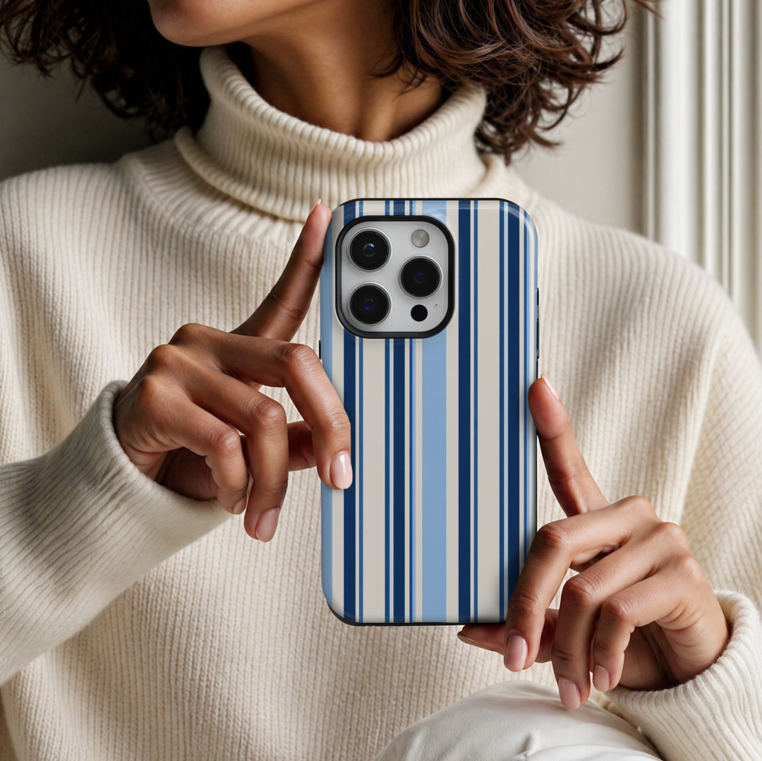 CASELIX Coastal Blue Stripe iPhone 18 Pro Max tough phone case featuring navy blue, light blue, and ivory vertical stripes with a glossy printed finish. Chic preppy striped phone case for women inspired by coastal fashion, nautical style, and classic blue aesthetics.