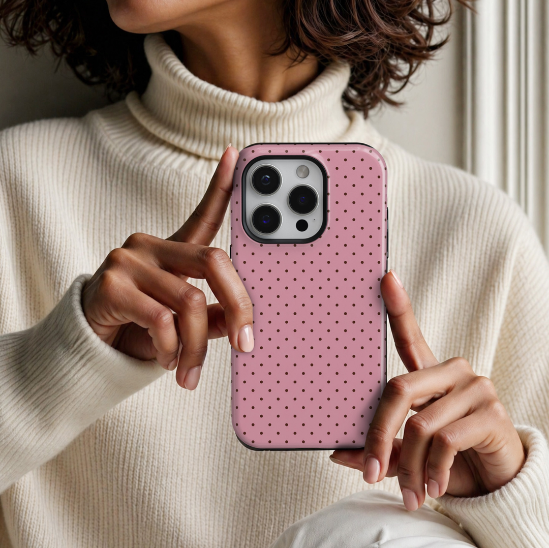 CASELIX Pink Espresso Dots iPhone 18 Pro Max tough phone case featuring a soft pastel pink background with tiny chocolate brown polka dots in a neat repeating pattern. Cute minimalist pink phone case for women with a glossy printed finish and trendy coquette-inspired aesthetic.