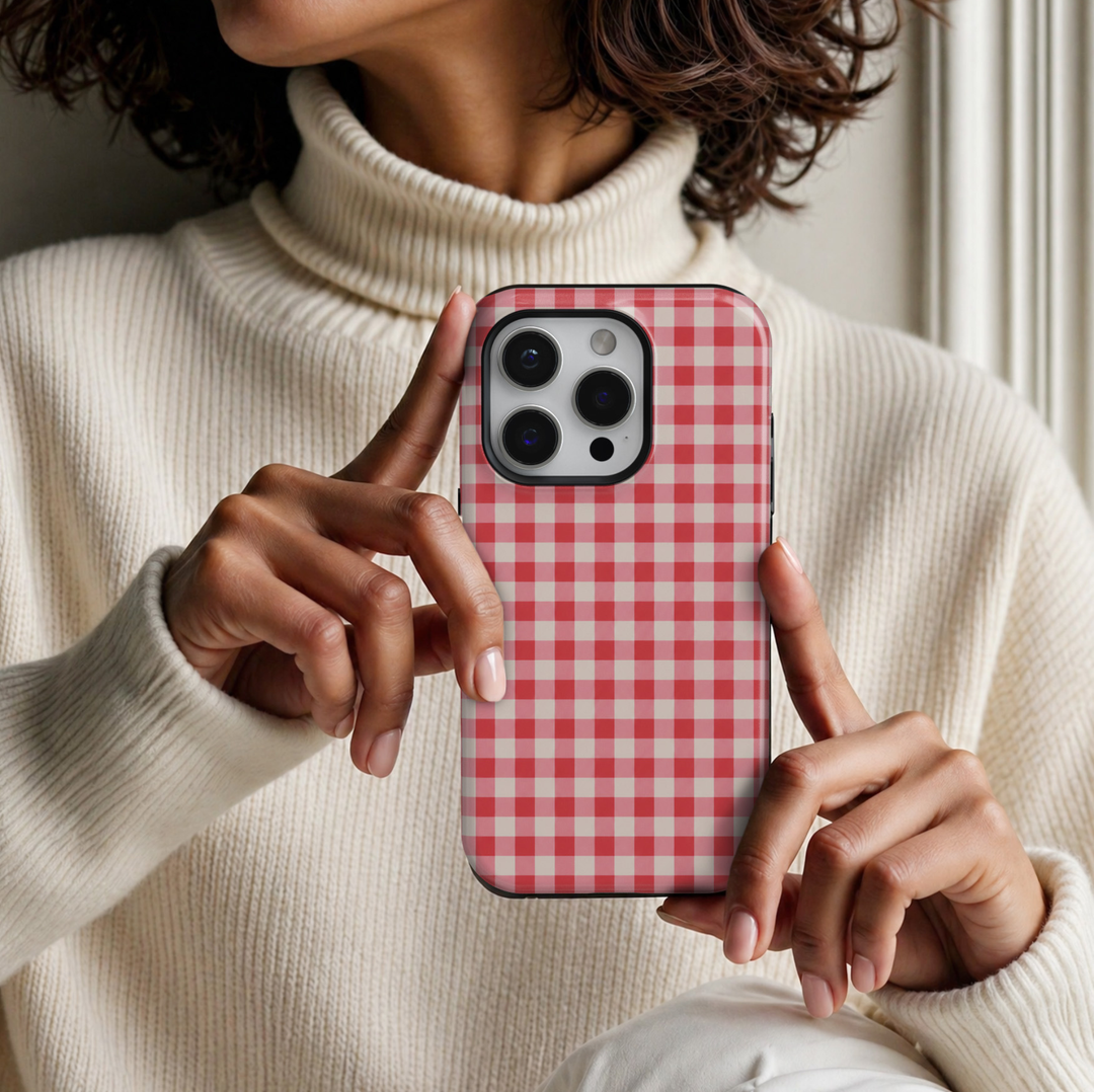CASELIX Strawberry Gingham iPhone 18 Pro Max tough phone case featuring a classic red, blush pink, and cream gingham checkered pattern with a glossy printed finish. Cute preppy aesthetic phone case for women with a feminine cottagecore style and timeless picnic-inspired design.