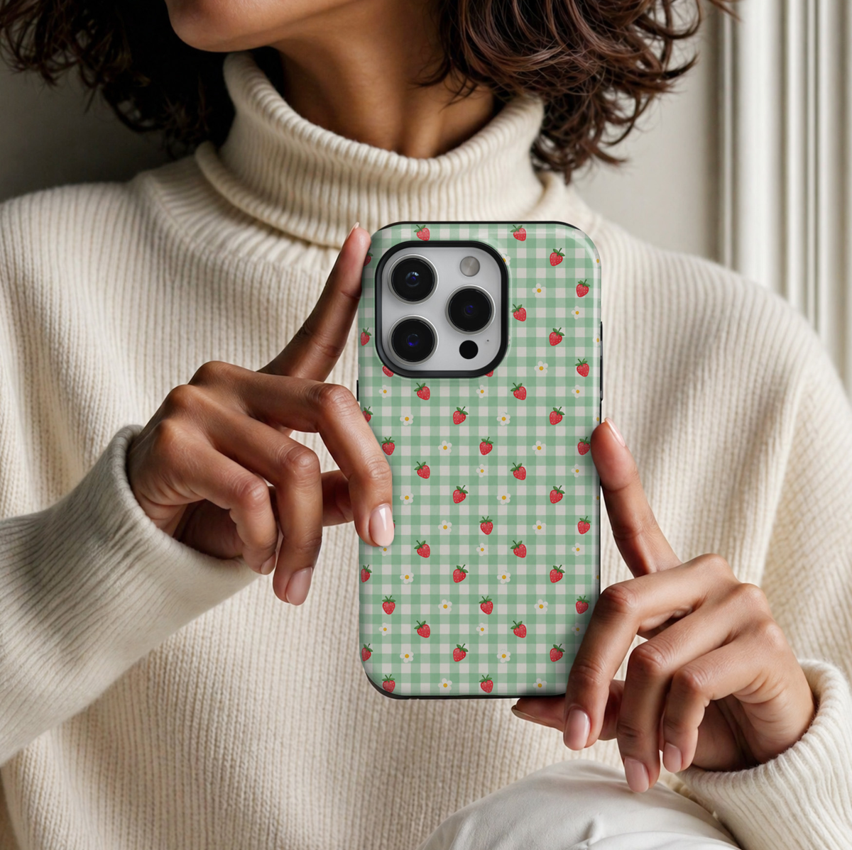 CASELIX Strawberry Meadow Gingham iPhone 18 Pro Max tough phone case featuring a pastel mint green and white gingham checkered pattern with tiny red strawberries and white daisy flowers. Cute cottagecore-inspired floral phone case for women with a glossy printed finish and charming strawberry aesthetic.