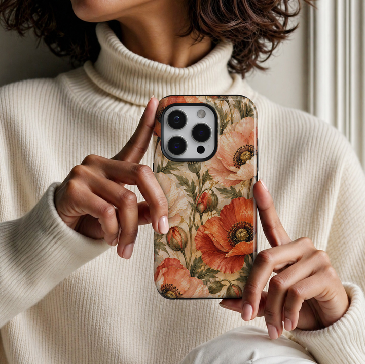 CASELIX August Birth Flower Poppy Radiance iPhone 18 Pro Max tough phone case featuring vibrant coral orange, peach and ivory poppy flowers with delicate gold accents, dark olive green leaves, and elegant floral buds against a luxurious cream marble-inspired background. A feminine botanical phone case with a warm romantic aesthetic, perfect for women who love elegant floral designs, sophisticated accessories, and meaningful August birthday gifts.