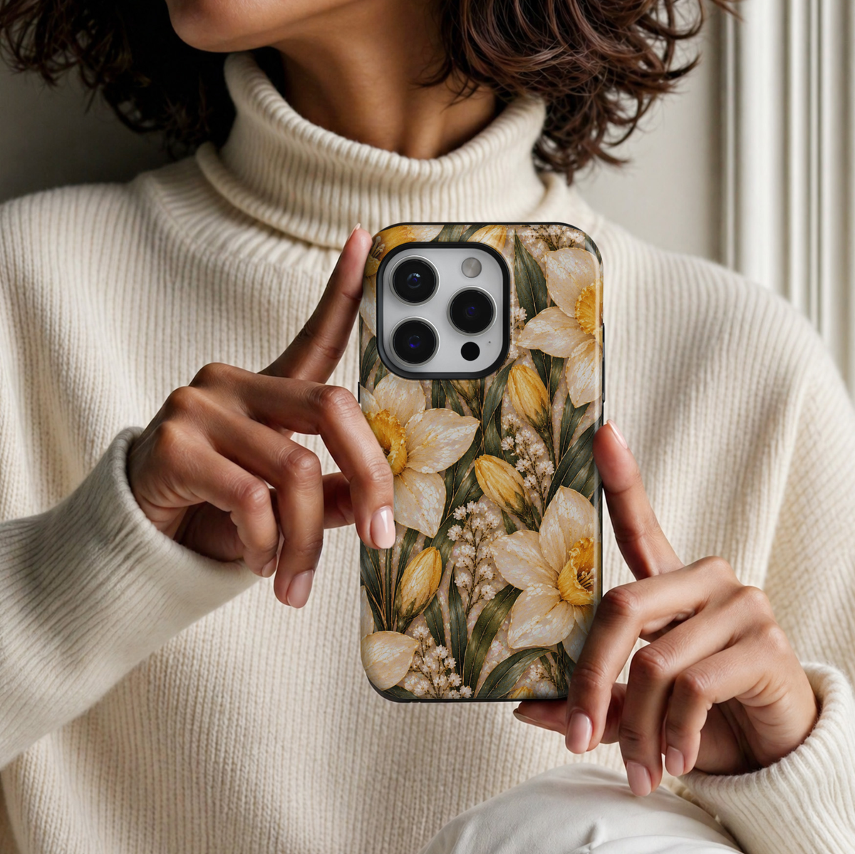 CASELIX March Birth Flower Golden Daffodil iPhone 18 Pro Max tough phone case featuring elegant ivory and golden yellow daffodil blossoms, delicate gold accents, deep sage green leaves, and a luminous pearlescent background. A beautiful feminine floral phone case with a luxurious botanical design, perfect for women who love spring flowers and meaningful birthday gifts.