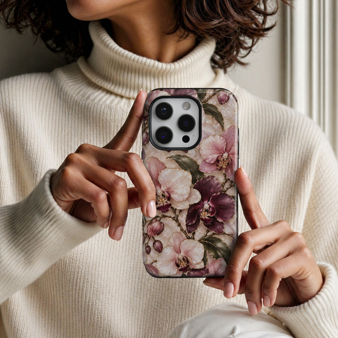 CASELIX April Birth Flower Orchid Elegance iPhone 18 Pro Max tough phone case featuring luxurious blush pink, ivory and deep burgundy orchids with delicate gold detailing, elegant dark green leaves and a luminous pearl-inspired background with a glossy printed finish.