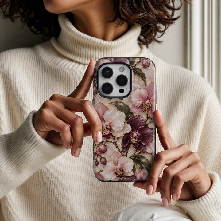 CASELIX April Birth Flower Orchid Elegance iPhone 18 Pro Max tough phone case featuring luxurious blush pink, ivory and deep burgundy orchids with delicate gold detailing, elegant dark green leaves and a luminous pearl-inspired background with a glossy printed finish.