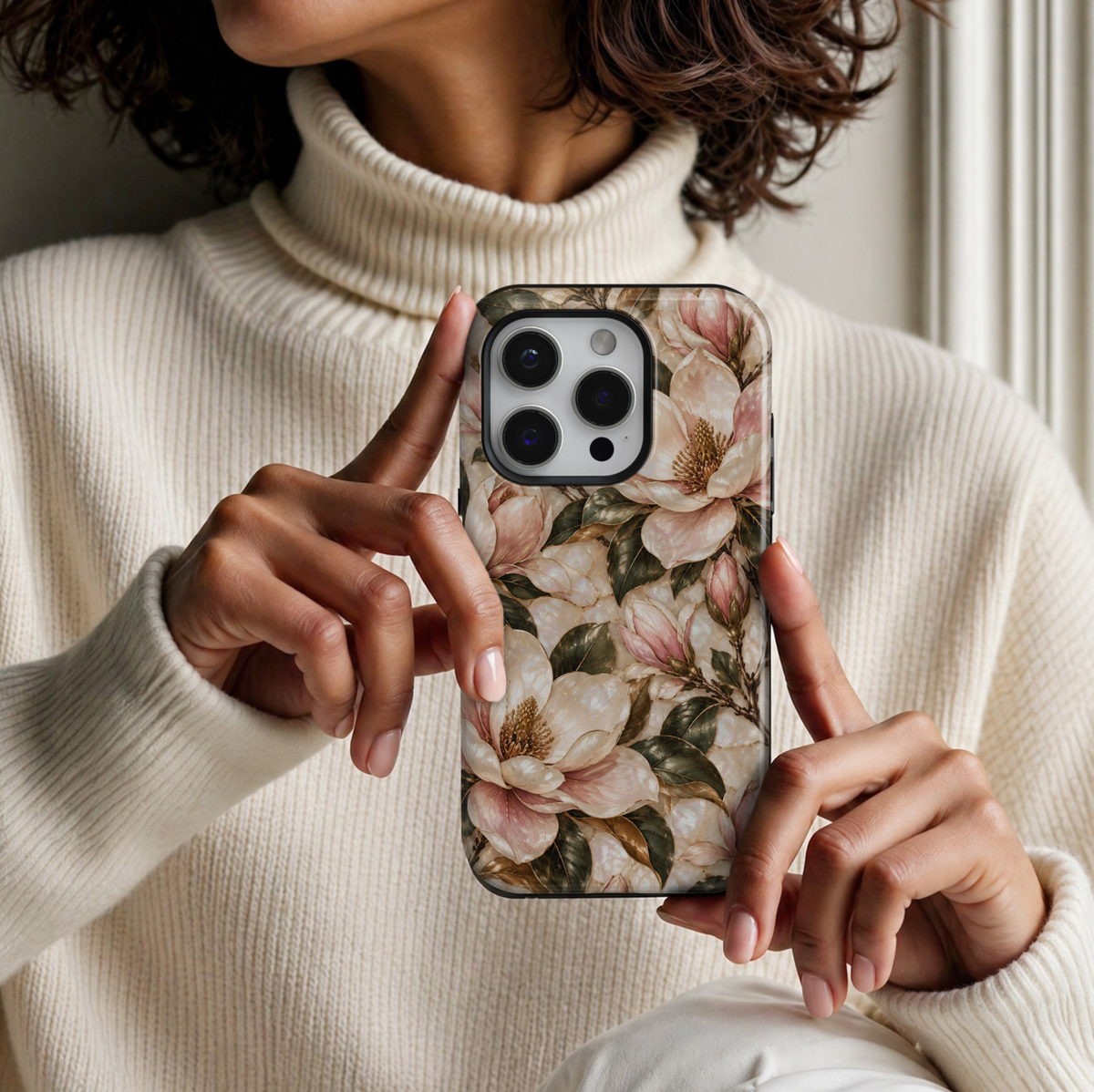 January birth flower iPhone 18 Pro Max case featuring Magnolia Grace with elegant ivory and blush pink magnolia blossoms, golden botanical accents, and deep green leaves on a champagne-inspired background with a glossy printed finish.