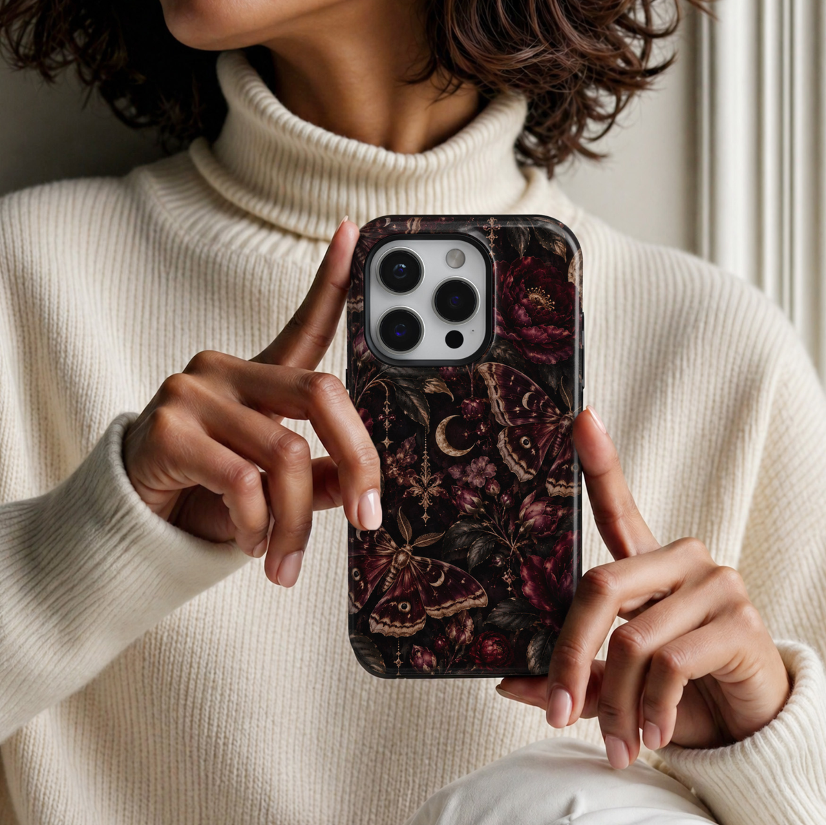 Midnight Moth iPhone 18 Pro Max tough phone case featuring elegant burgundy and bronze moths, deep wine-red roses, delicate floral buds, antique gold crescent moons, ornate celestial charms and dark botanical foliage against a dramatic black background with a glossy printed finish.