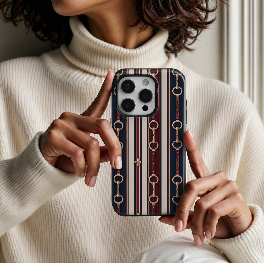 Equestrian Stripes iPhone 18 Pro Max tough case featuring classic navy blue, burgundy and ivory vertical stripes, gold horsebit hardware, leather-inspired equestrian straps and elegant fleur-de-lis accents with a glossy finish.