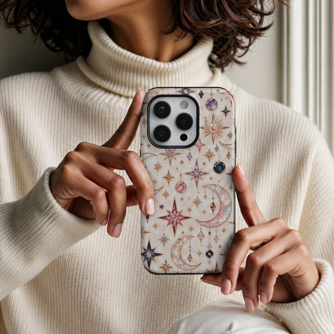 CASELIX Celestial Opal iPhone 18 Pro Max case featuring iridescent pearl crescent moons, pink and lavender gemstones, sapphire blue crystals, delicate gold stars, and celestial charms on an elegant ivory background with a glossy printed finish.