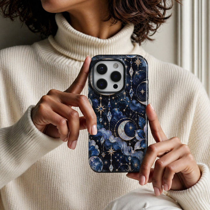 CASELIX Midnight Sapphire iPhone 18 Pro Max case featuring luminous pearl crescent moons, sapphire blue gemstones, delicate gold constellations, sparkling celestial stars and swirling midnight blue clouds against a deep navy background with a glossy printed finish.