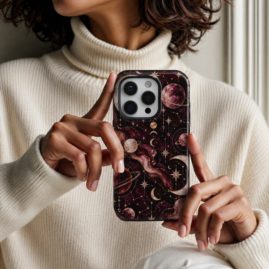 CASELIX Celestial Galaxy iPhone 18 Pro Max case featuring shimmering gold crescent moons, rose gold planets, sparkling stars, celestial constellations and gemstone-inspired details against a deep burgundy and black cosmic background with a glossy printed finish.