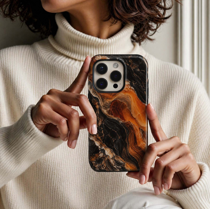 Pumpkin Onyx Tough iPhone Case featuring molten pumpkin orange and burnt amber marble flowing through deep black onyx with cream and caramel natural stone veining.