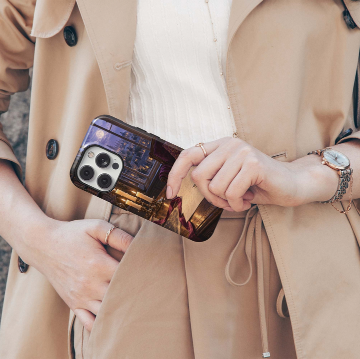 Letters After Dark Tough iPhone Case featuring handwritten letters, sealed envelopes, a fountain pen, burgundy ribbon and glowing candles on an antique desk overlooking an old-world town at night.
