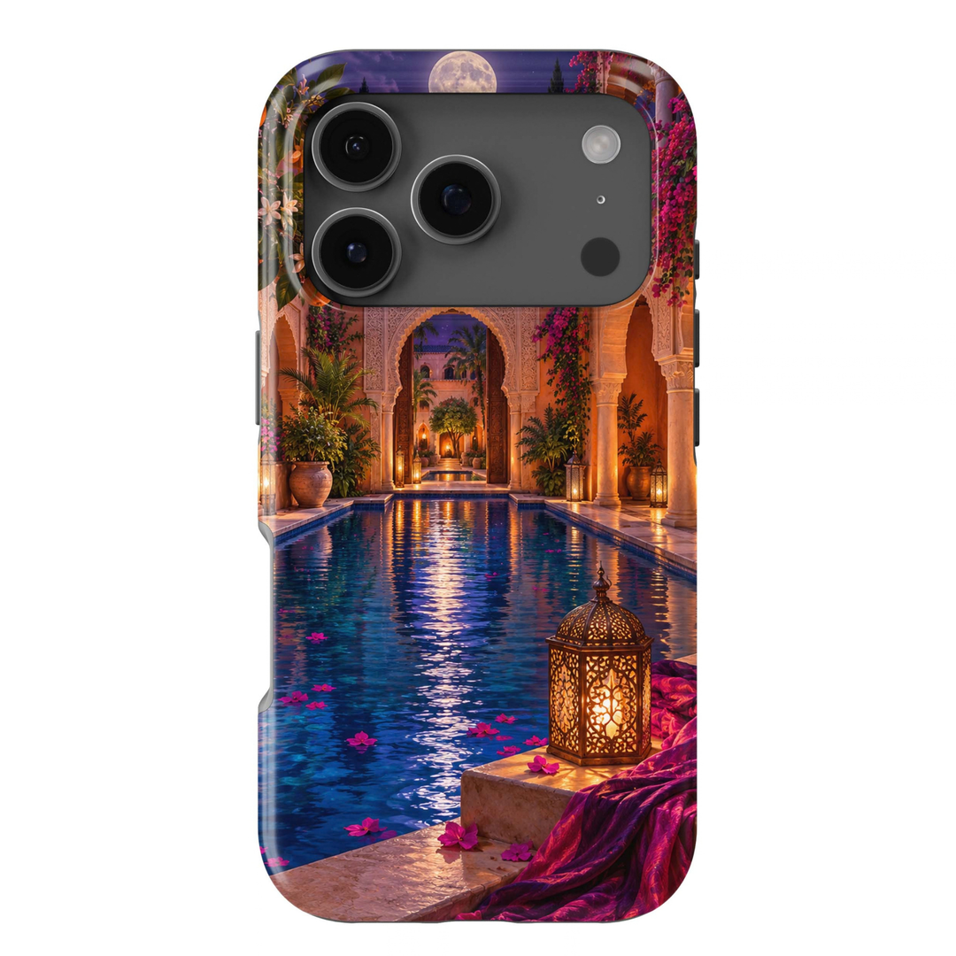 Moonwater Riad Tough iPhone Case featuring a moonlit Moroccan-inspired courtyard with a deep blue reflecting pool, ornate glowing lanterns, bougainvillea, arches and rich magenta textiles.
