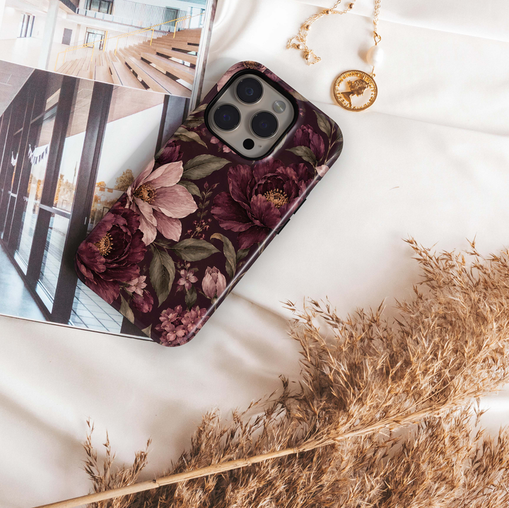 Merlot Garden iPhone 18 Pro Max MagSafe case featuring oversized merlot, burgundy and dusty blush flowers with muted olive foliage on a dark wine background, an elegant moody botanical tough iPhone 18 Pro floral phone case with MagSafe compatibility.