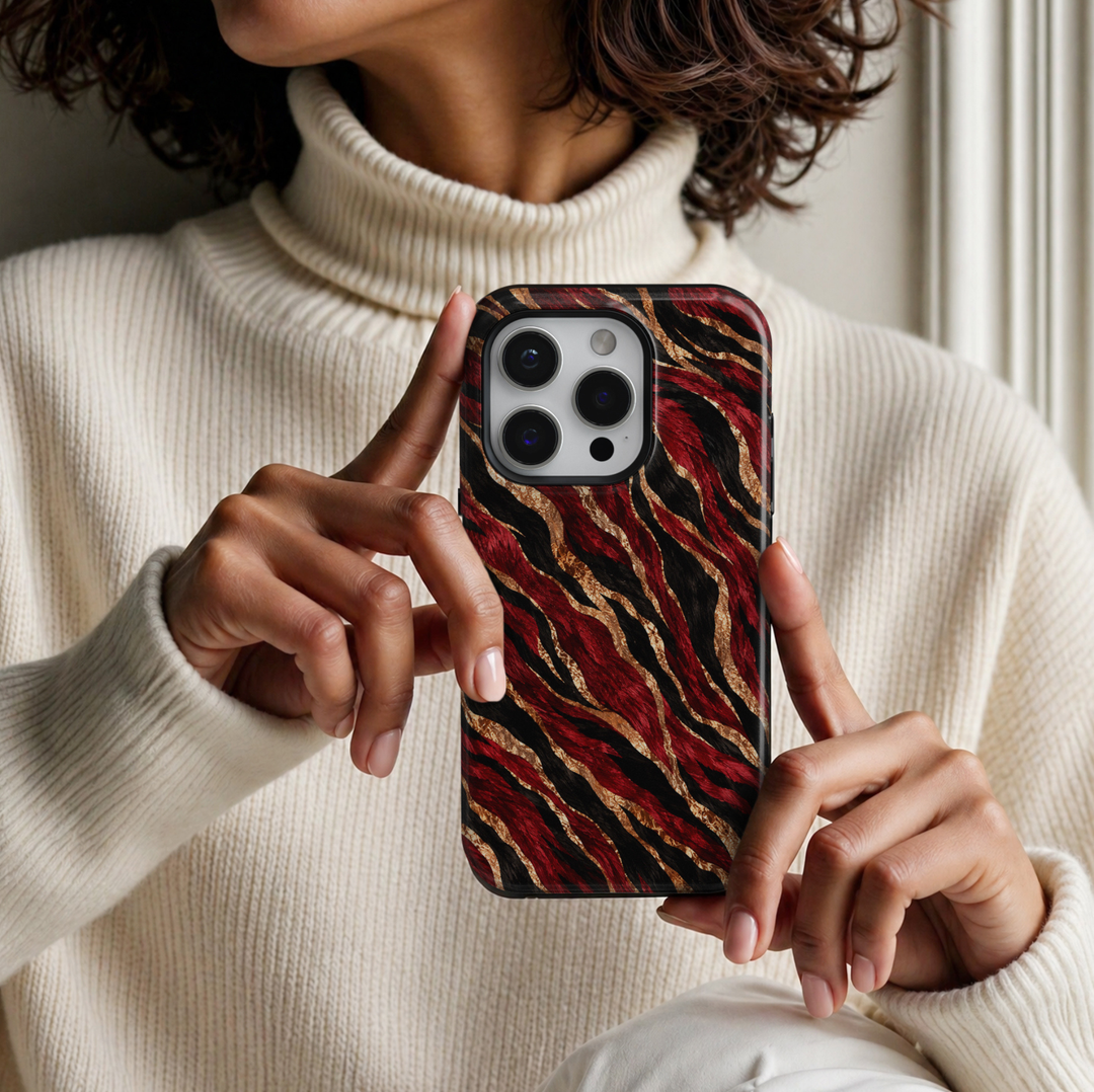 CASELIX Crimson Gold Zebra iPhone Tough MagSafe protective phone case featuring a luxurious abstract zebra-inspired animal print pattern with flowing, irregular stripes in vibrant crimson red, midnight black, and shimmering champagne gold. The striking design showcases bold ruby-red and jet-black zebra stripes intertwined with brilliant metallic gold-inspired ribbons, creating a dramatic, high-fashion aesthetic. Each stripe features intricate faux-fur brushstroke textures, natural-looking directional patter