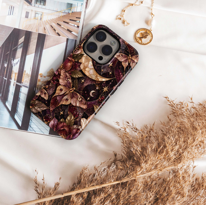 Midnight Moth iPhone 18 Pro Max MagSafe case featuring a jeweled celestial moth, crescent moons, stars and dark botanical details in burgundy, plum, champagne and antique gold, a luxurious stained-glass-inspired tough iPhone 18 Pro phone case with MagSafe compatibility.