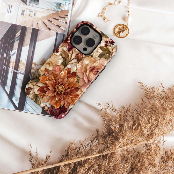 Harvest Dahlia iPhone 18 Pro Max MagSafe case featuring stained-glass-inspired dahlias and roses in copper, caramel, champagne, burgundy, blush and ivory with antique gold detailing, a luxurious autumn floral tough iPhone 18 Pro phone case with MagSafe compatibility.