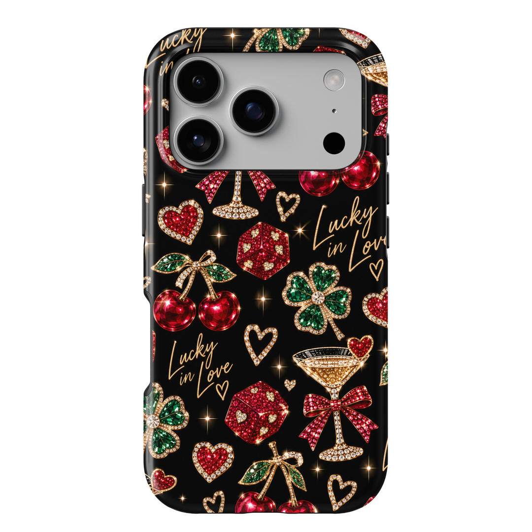 CASELIX Lucky in Love iPhone 18 Pro Max tough phone case featuring a glossy black background with ruby-red jeweled cherries, emerald-green four-leaf clovers, sparkling red dice, crystal hearts, gold cocktail glasses, and red satin bows. Chic printed phone case for women with gold Lucky in Love lettering, a playful romantic aesthetic, and glamorous girls&