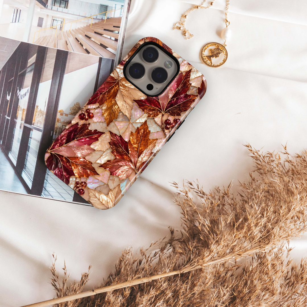 Autumn Opal iPhone 18 Pro Max MagSafe case featuring pearlescent autumn maple leaves in burgundy, copper, bronze, champagne and ivory with red berries and gold detailing, a luxurious stained-glass-inspired tough iPhone 18 Pro fall phone case with MagSafe compatibility.