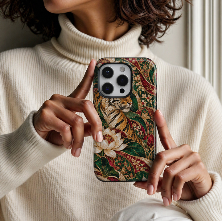 CASELIX Royal Bengal Garden iPhone Tough MagSafe protective phone case featuring a majestic Bengal tiger surrounded by luxurious emerald-green, ruby-red, champagne-gold, and iridescent ivory stained-glass botanical artwork. The captivating design showcases an elegantly illustrated golden tiger with intricate black stripes, realistic facial details, and luminous amber tones, emerging from a richly decorated tropical garden. Oversized pearlescent white lotus flowers with ruby-red centers bloom among sweeping 