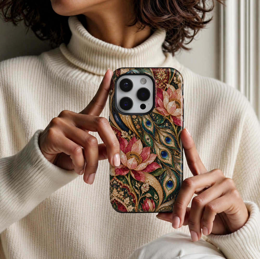 CASELIX Royal Peacock Garden iPhone Tough MagSafe protective phone case featuring a luxurious peacock feather and lotus floral stained-glass mosaic design in rich emerald green, sapphire blue, ruby red, blush pink, and champagne gold. The exquisite artwork showcases an elegant arrangement of flowing peacock feathers adorned with brilliant cobalt-blue eye motifs, luminous turquoise accents, and intricate golden detailing. Gracefully intertwined feathers sweep across the design alongside oversized pink and ru
