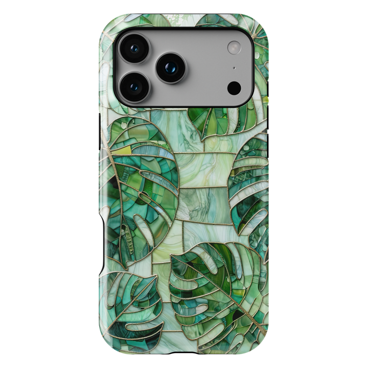 Green stained glass iPhone case featuring layered monstera leaves in emerald, jade, and sage botanical mosaic artwork.